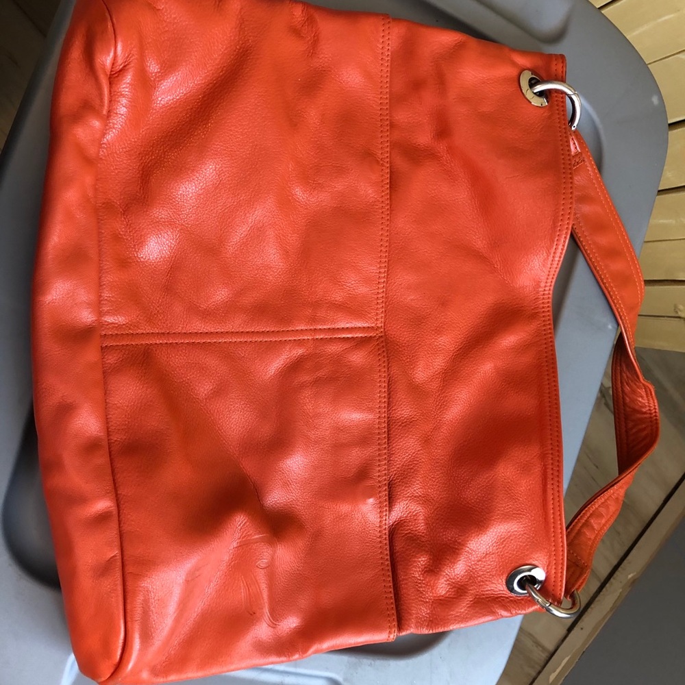 Gently used orange leather hobo bag